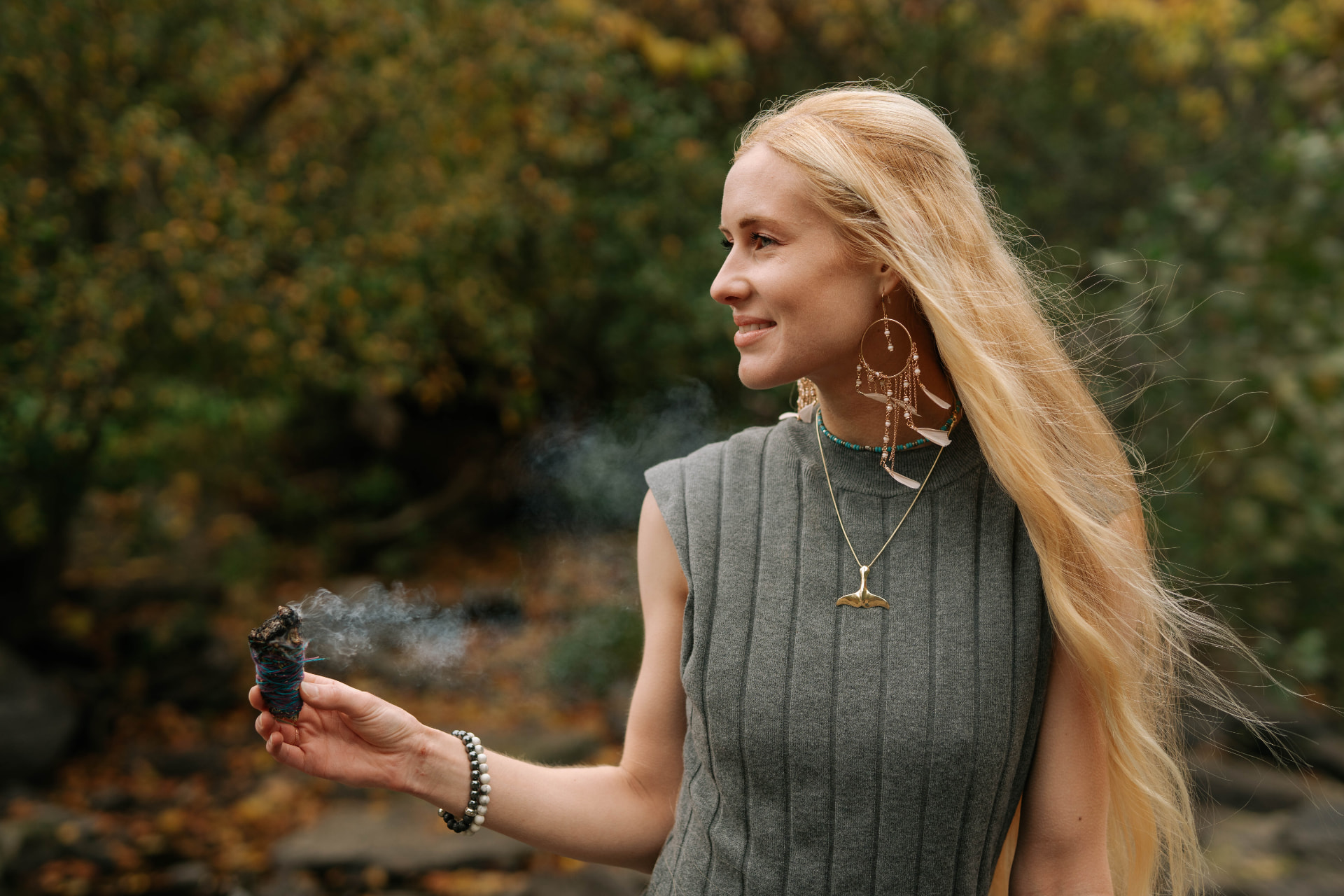 Sarah Cushing smiling outdoors among autumn trees