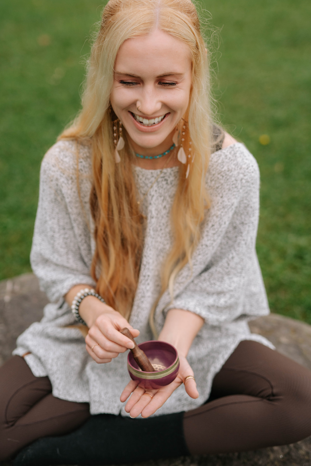 Sarah laughing while playing a singing bowl