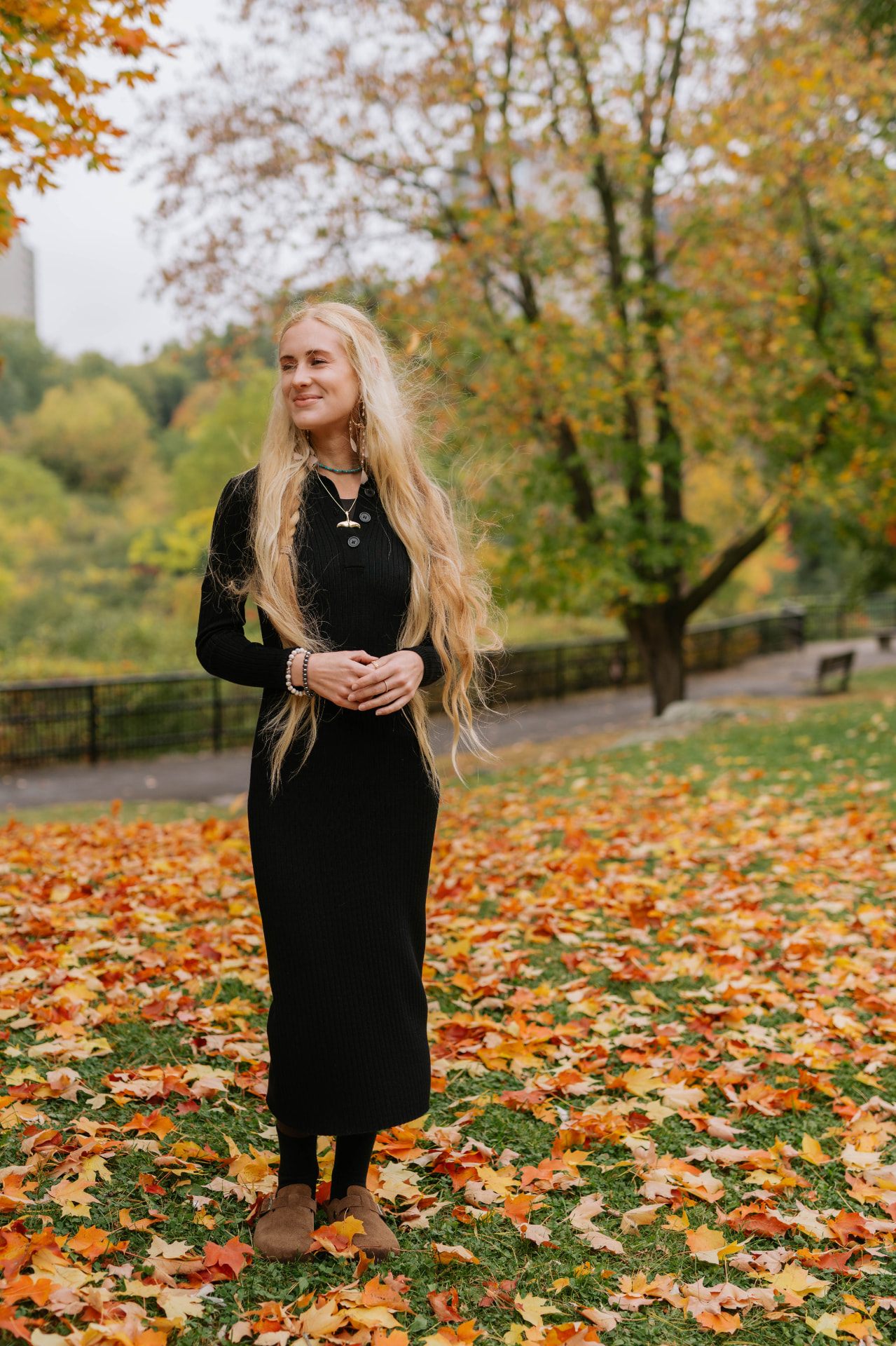 Sarah Cushing standing among fallen autumn leaves