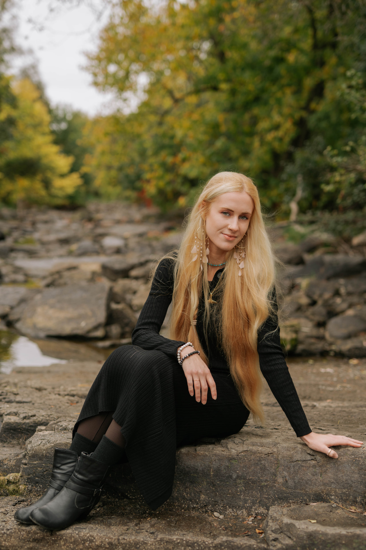 Sarah Cushing seated on a rocky riverbank in Ottawa