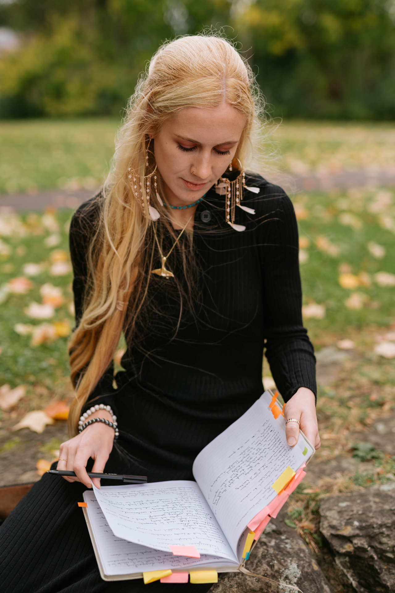 Sarah Cushing reading through handwritten notes outdoors