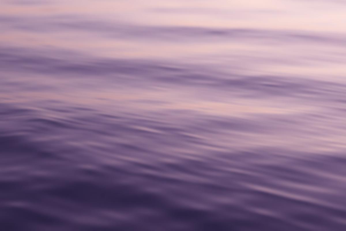 Calm lavender water rippling at dusk